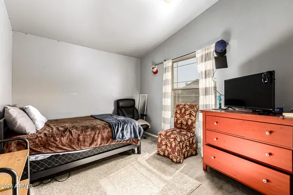 a bedroom with a bed and flat screen tv