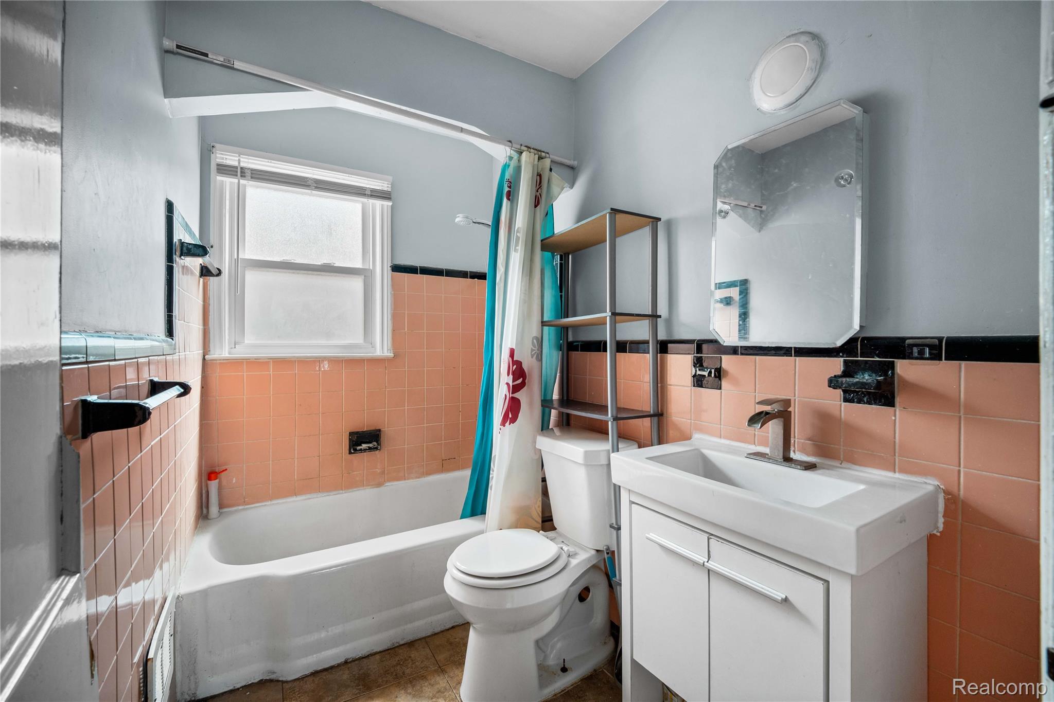 4049 Williams Street Inkster, MI 48141 - Photo 12 of 21 Bathroom with vanity, tile walls, shower / bathtub combination with curtain, wainscoting, and tile patterned floors