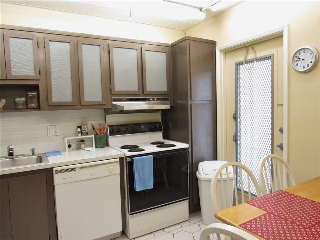 2661 South Course Drive, Unit 404 Pompano Beach, FL 33069 - Photo 13 of 16 a view of kitchen with stainless steel appliances granite countertop a stove a sink and a refrigerator