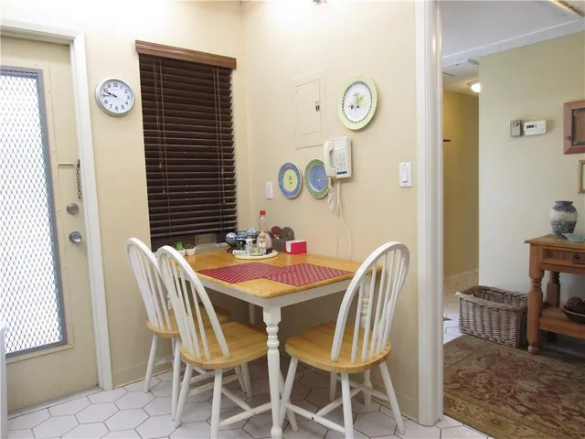a view of a dining room with furniture and a window