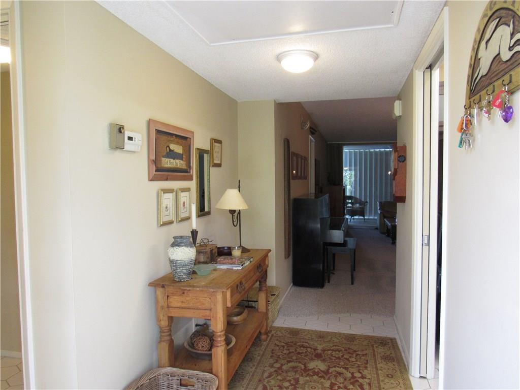 2661 South Course Drive, Unit 404 Pompano Beach, FL 33069 - Photo 7 of 16 a room with furniture a rug and a painting