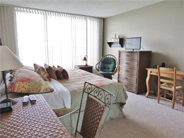 a bedroom with furniture and a window