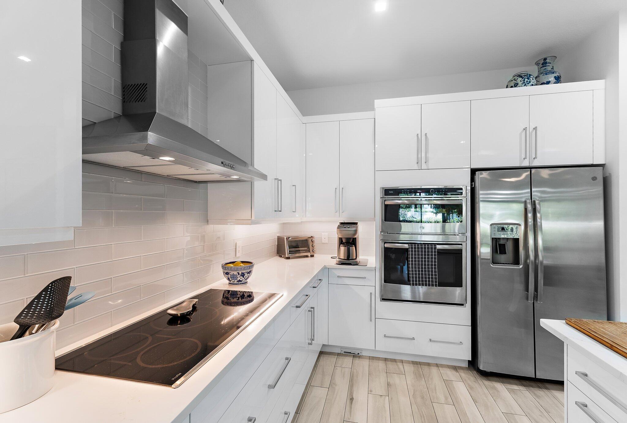 2908 Gin Berry Way West Palm Beach, FL 33401 - Photo 11 of 70 a kitchen with a sink a stove and refrigerator