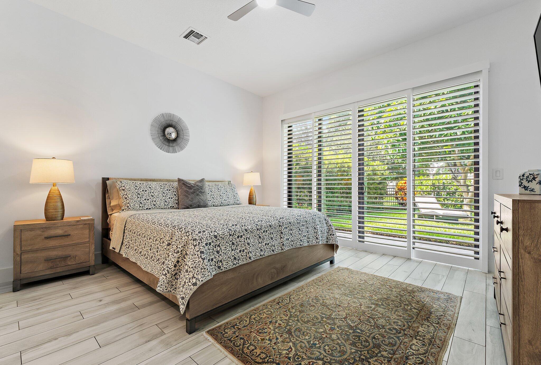 2908 Gin Berry Way West Palm Beach, FL 33401 - Photo 18 of 70 a bedroom with a large bed and a large window