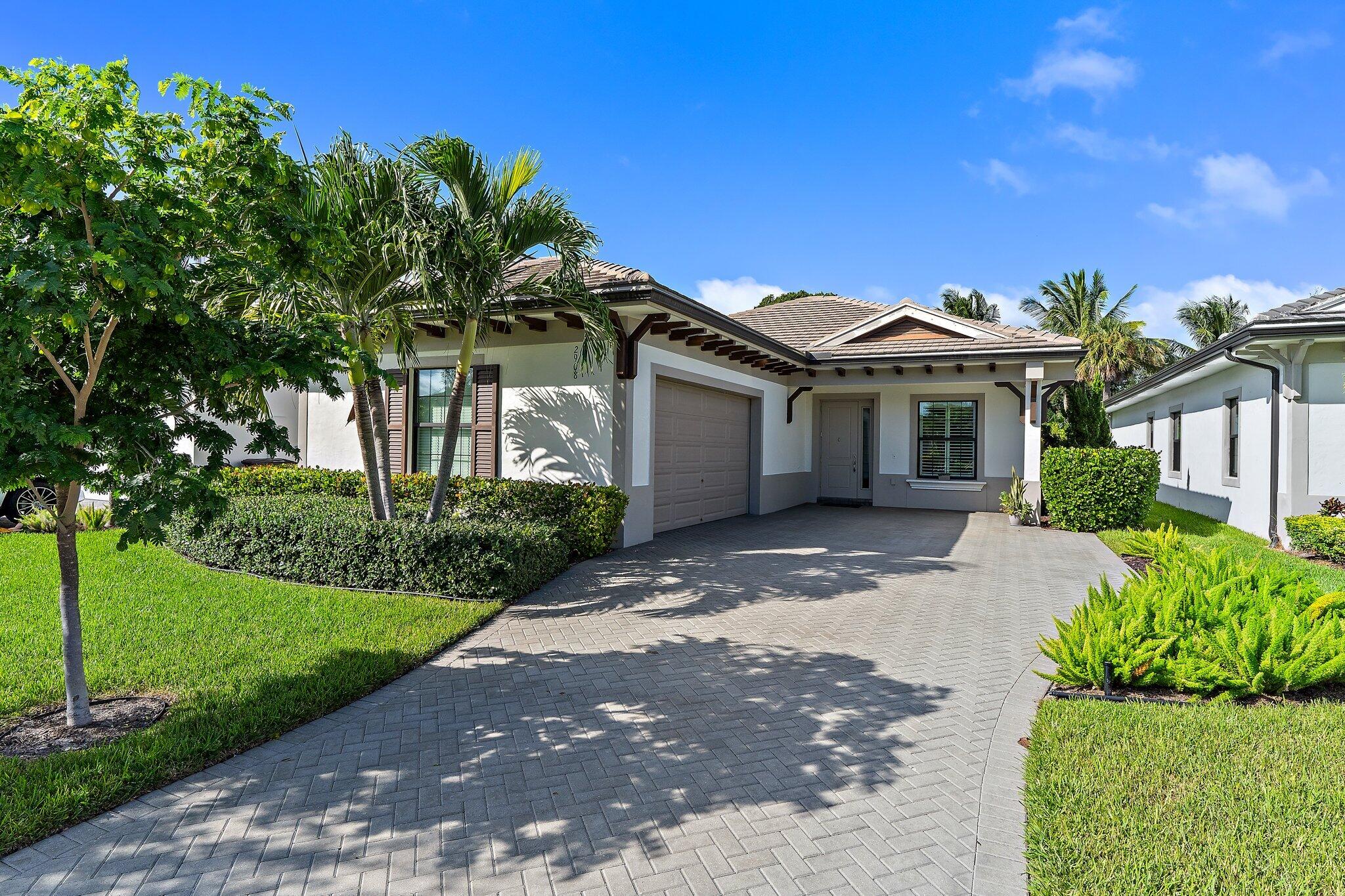 2908 Gin Berry Way West Palm Beach, FL 33401 - Photo 2 of 70 a front view of a house with a yard