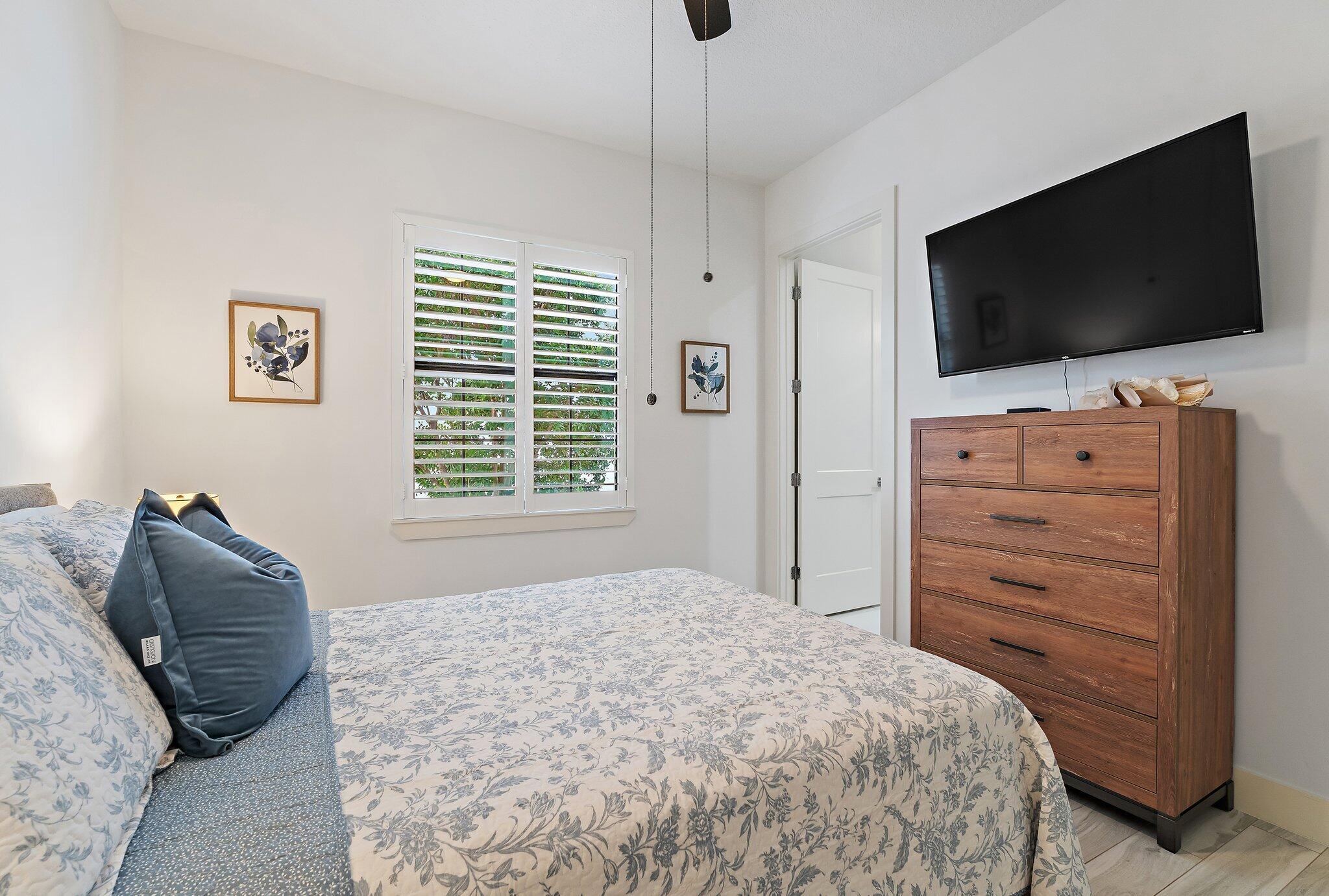 2908 Gin Berry Way West Palm Beach, FL 33401 - Photo 28 of 70 a bedroom with a bed and a flat screen tv