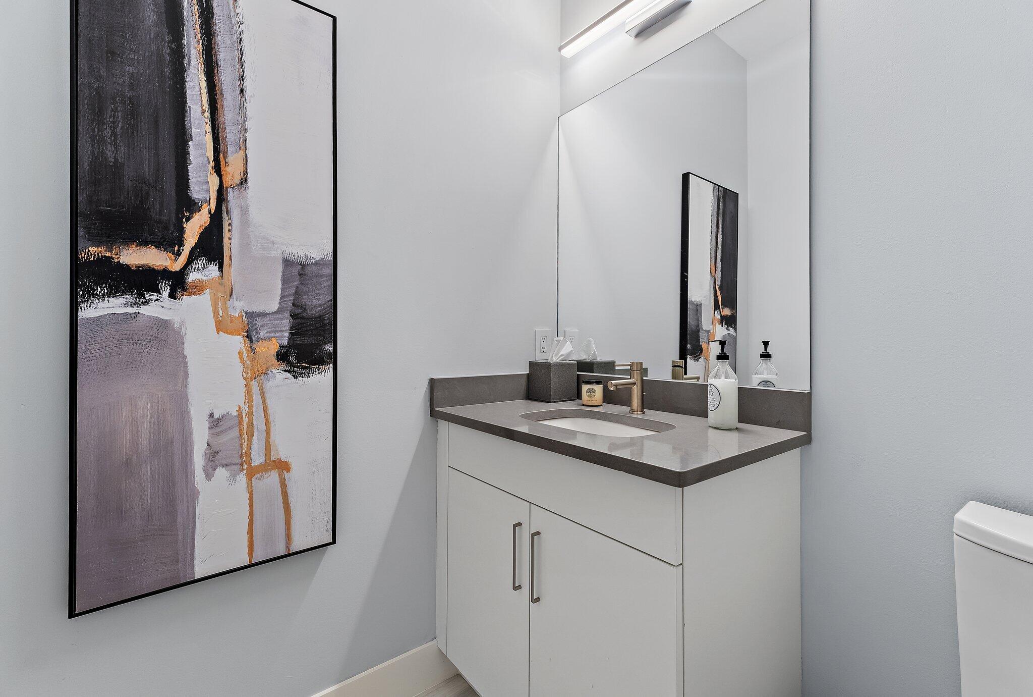 2908 Gin Berry Way West Palm Beach, FL 33401 - Photo 34 of 70 a bathroom with a granite countertop sink and a mirror