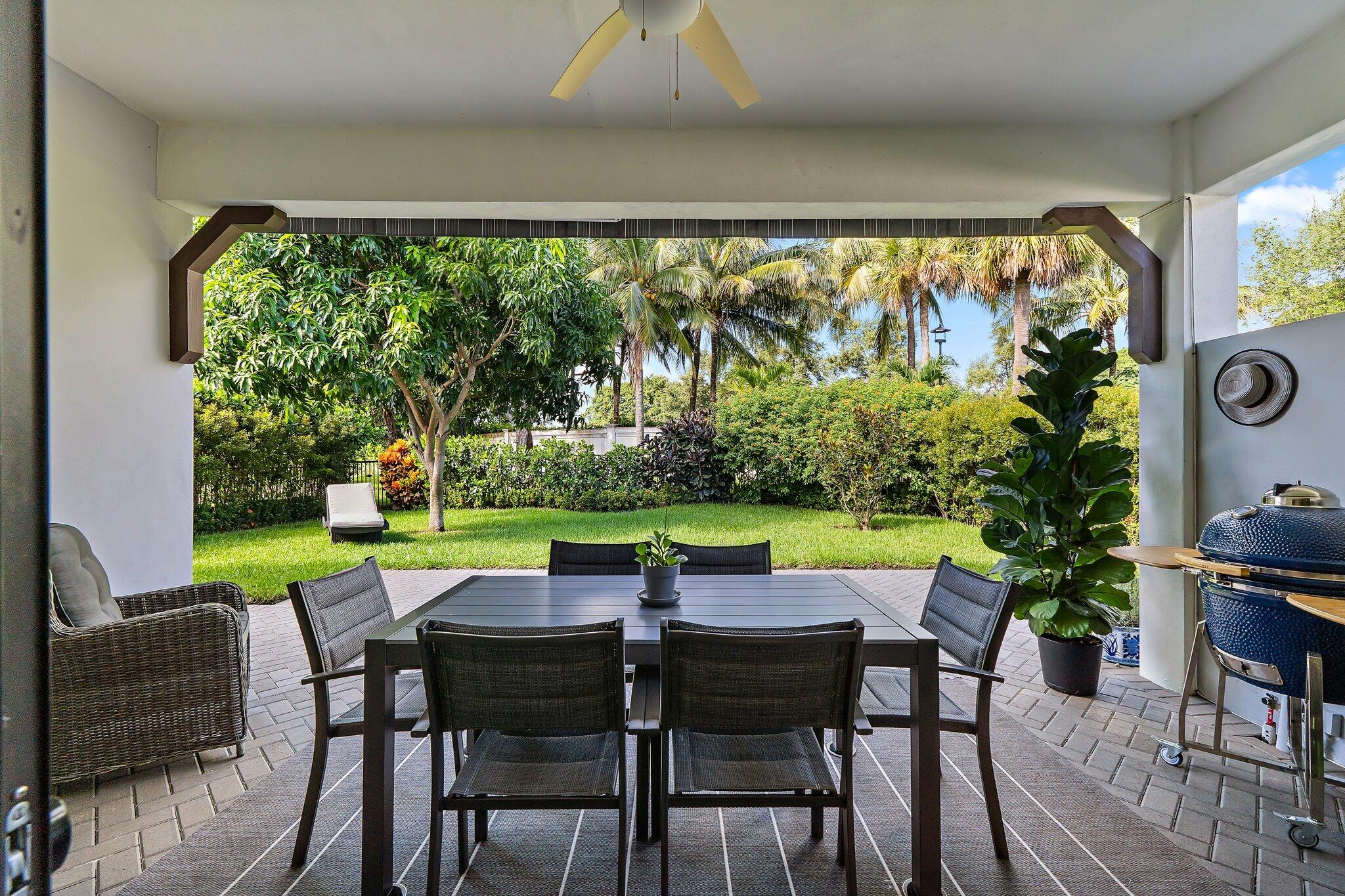 2908 Gin Berry Way West Palm Beach, FL 33401 - Photo 35 of 70 a view of a chairs and table in patio with a yard