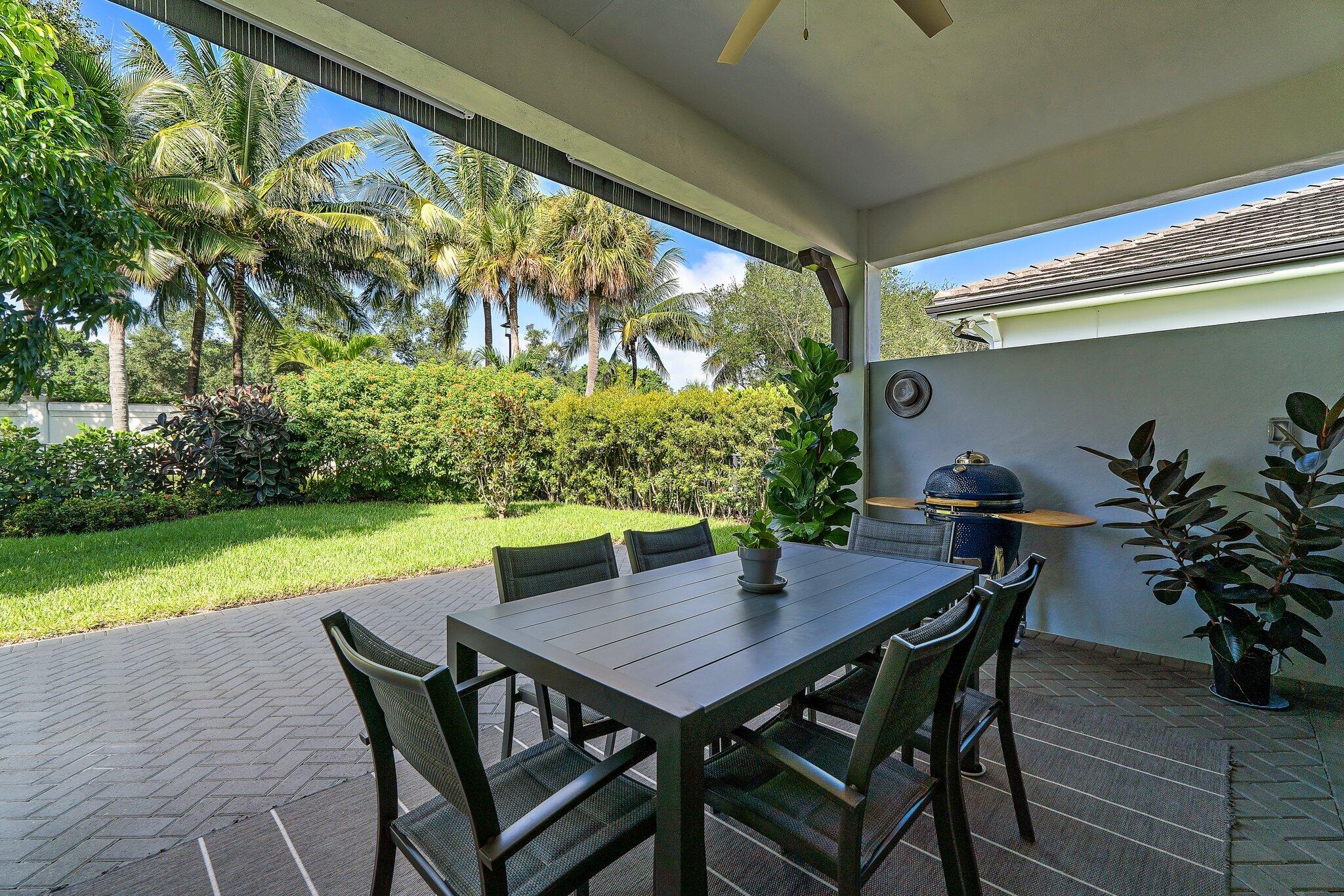 2908 Gin Berry Way West Palm Beach, FL 33401 - Photo 36 of 70 a view of an outdoor dining space with furniture and garden
