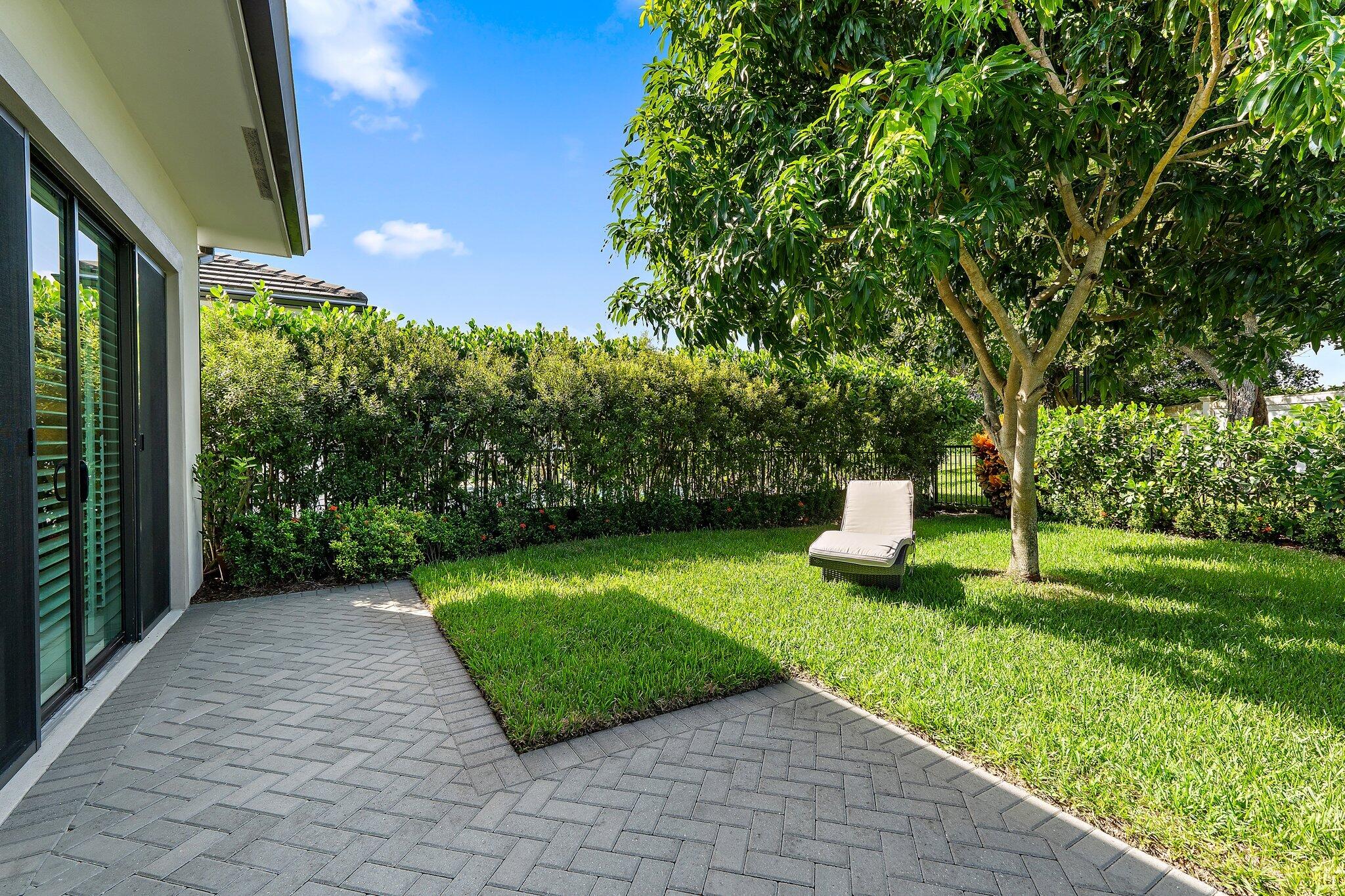 2908 Gin Berry Way West Palm Beach, FL 33401 - Photo 39 of 70 a view of a chair and table in the garden