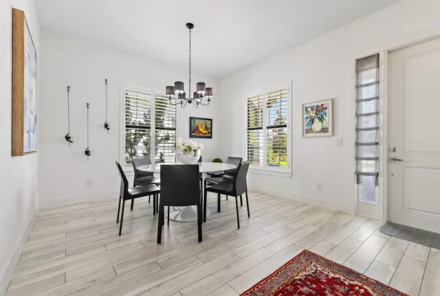a view of a dining room with furniture wooden floor and a chandelier