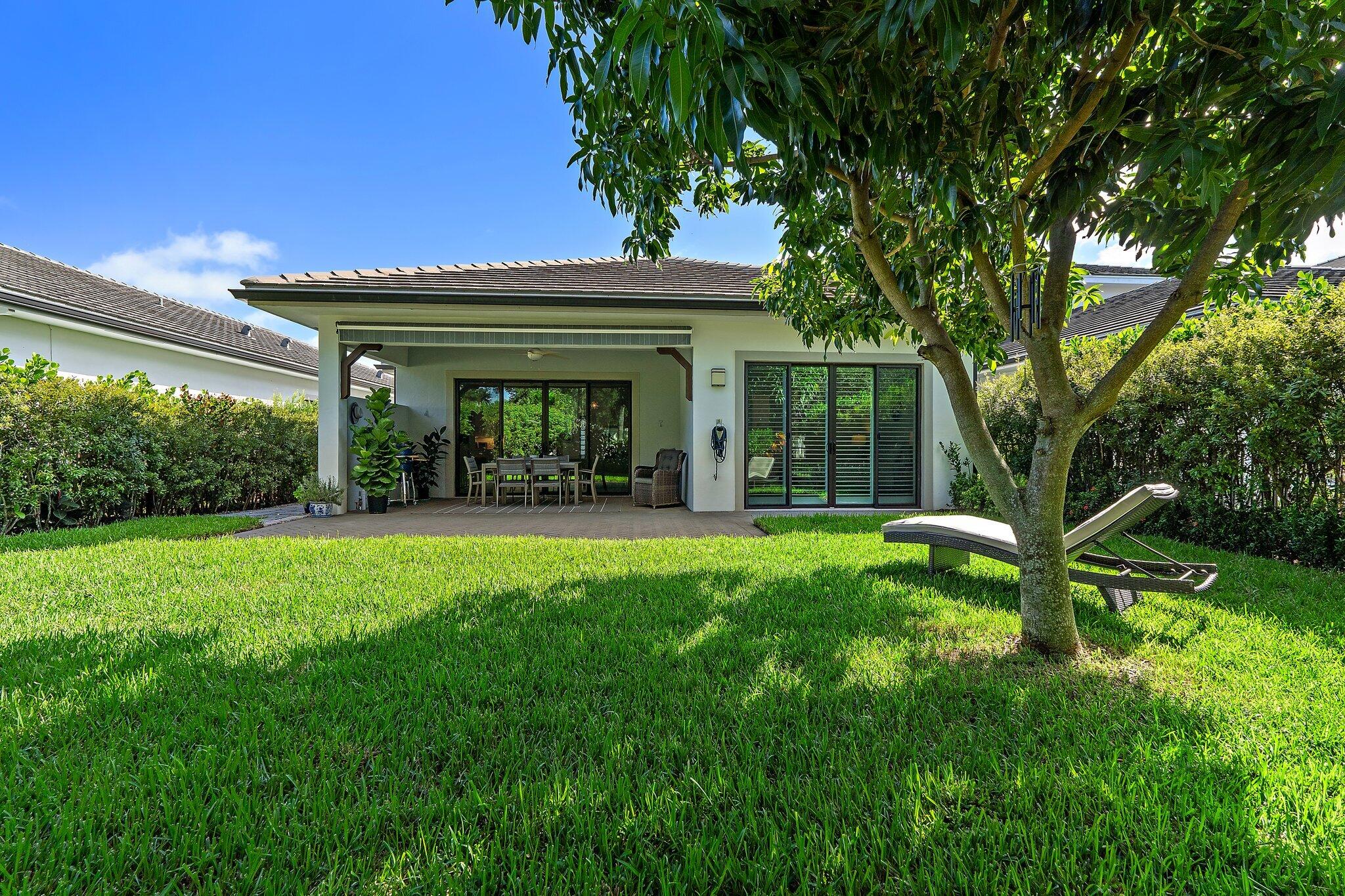 2908 Gin Berry Way West Palm Beach, FL 33401 - Photo 43 of 70 a view of a house with backyard porch and sitting area