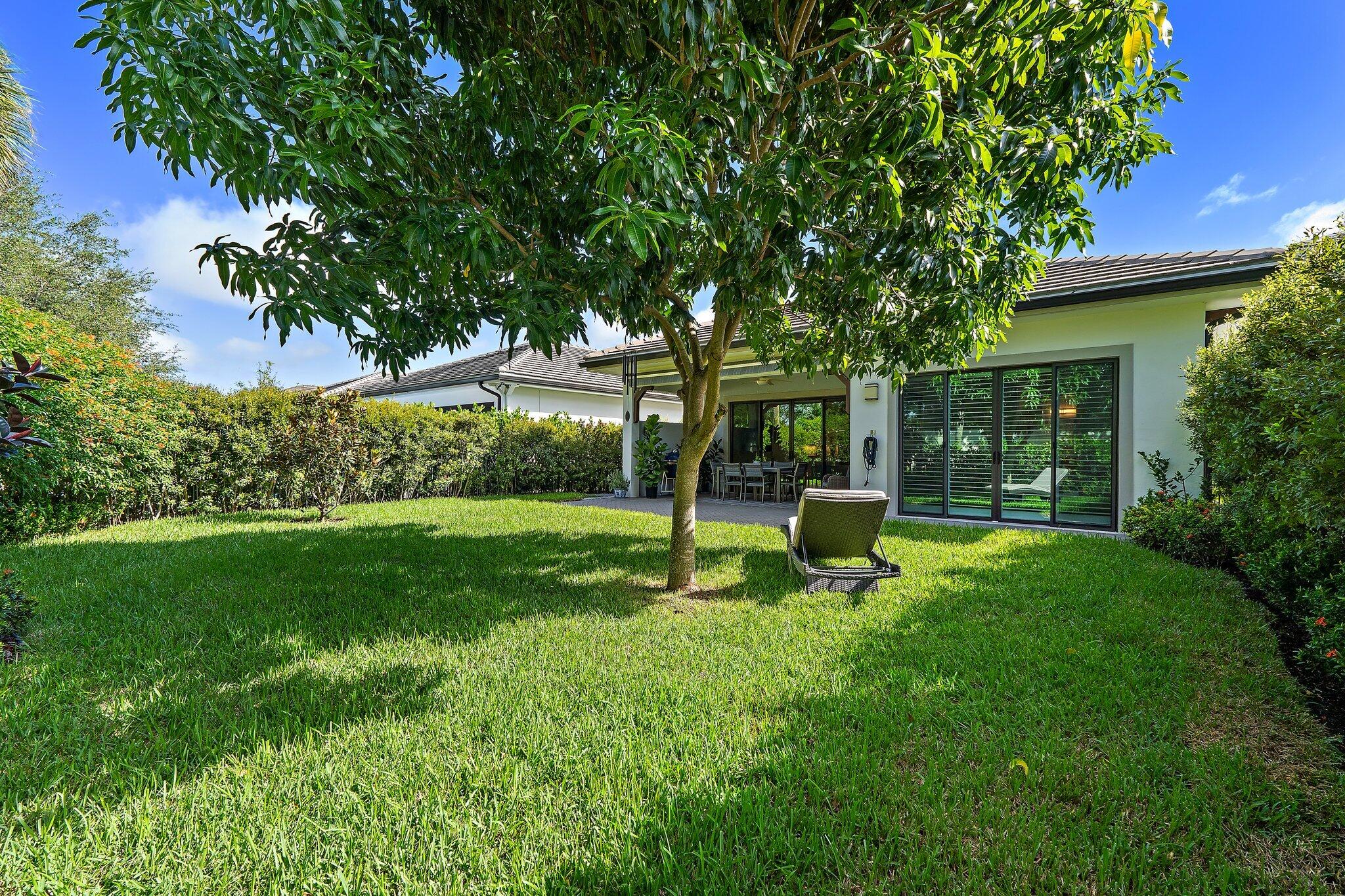 2908 Gin Berry Way West Palm Beach, FL 33401 - Photo 44 of 70 a garden with trees in front of it