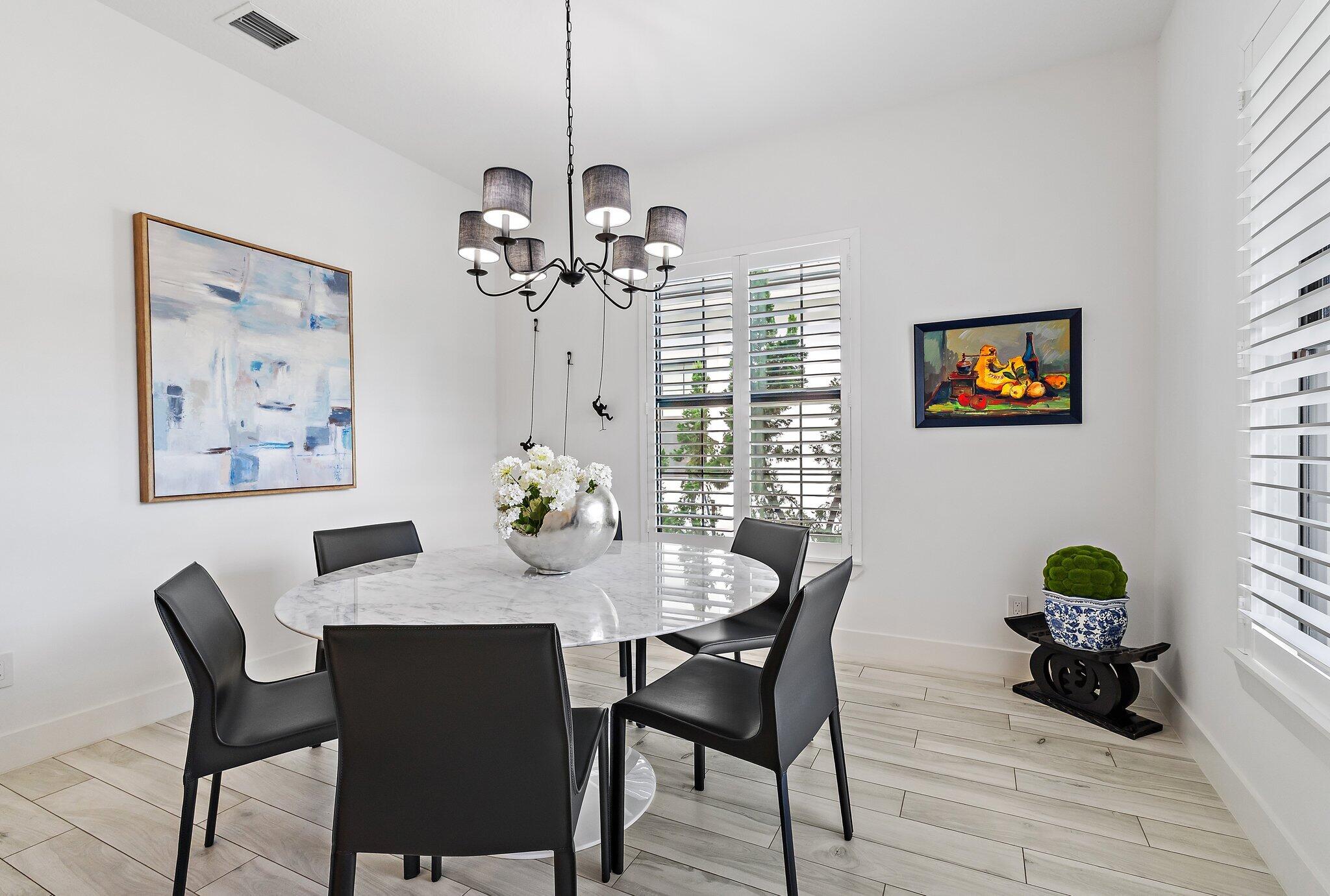 2908 Gin Berry Way West Palm Beach, FL 33401 - Photo 5 of 70 a view of a dining room with furniture wooden floor and a chandelier