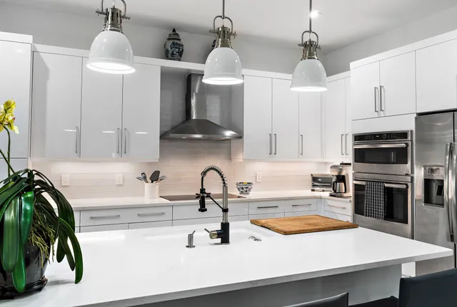 a kitchen with stainless steel appliances kitchen island granite countertop a sink and cabinets