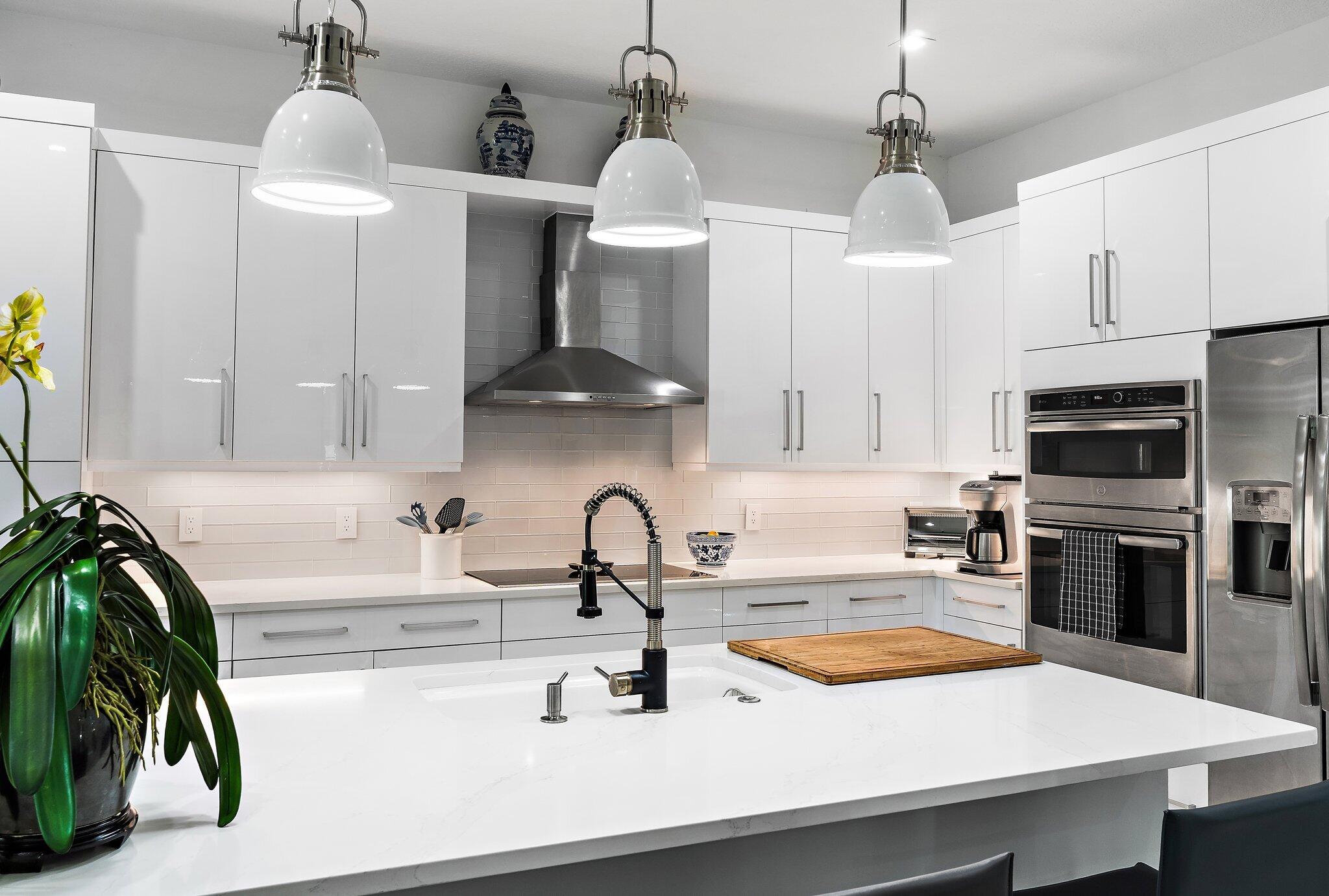 2908 Gin Berry Way West Palm Beach, FL 33401 - Photo 8 of 70 a kitchen with stainless steel appliances a sink a stove and a wooden floors