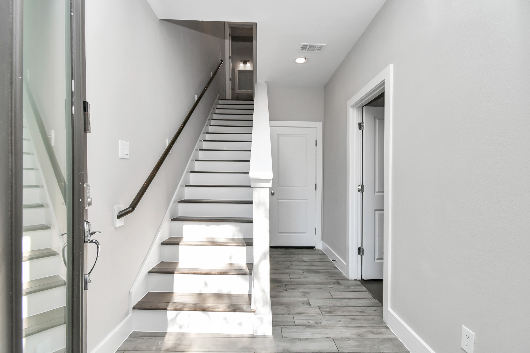 308 Palmer Street Houston, TX 77003 - Photo 4 of 36 a view of staircase with white walls and black white walls
