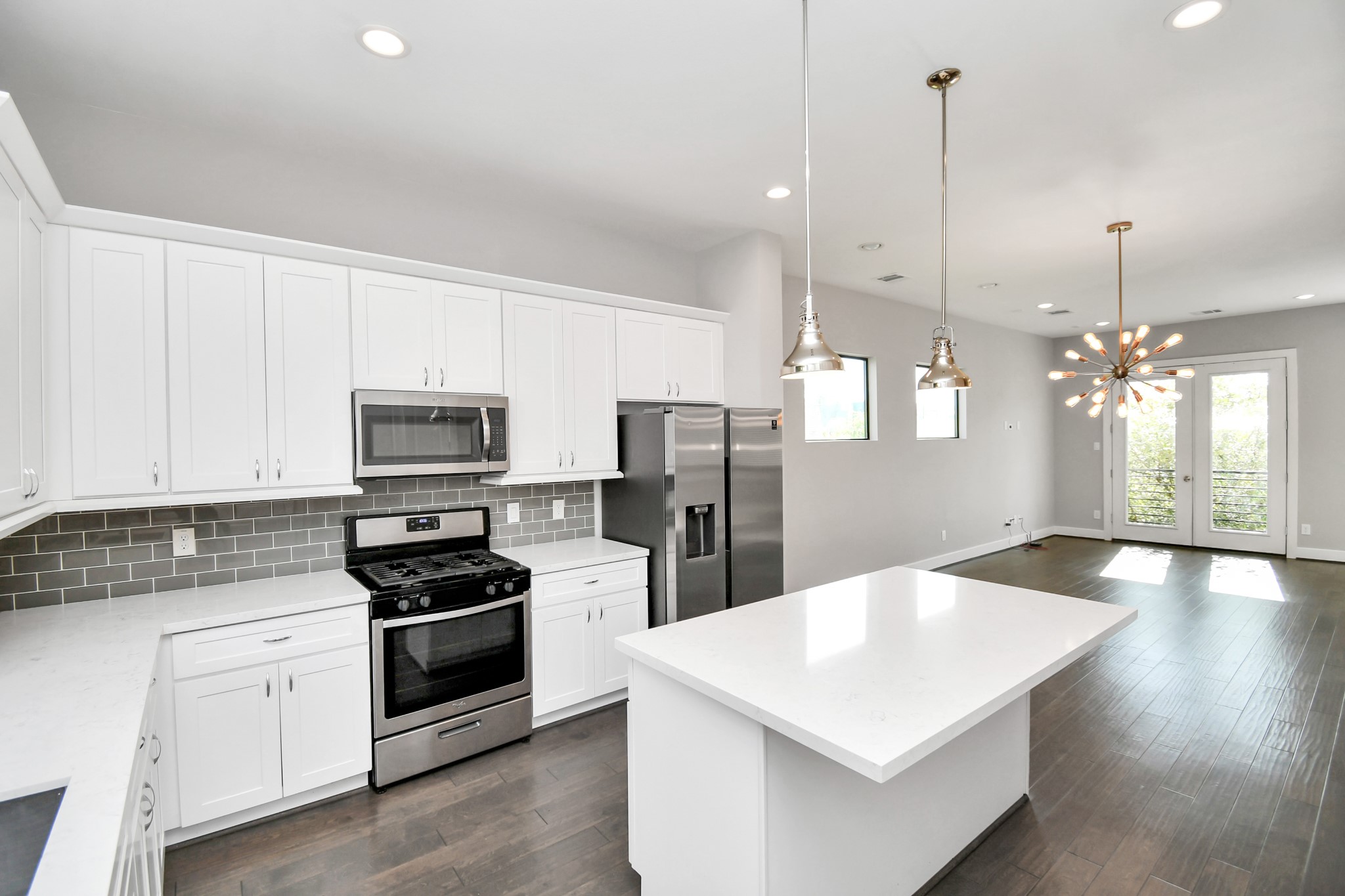 308 Palmer Street Houston, TX 77003 - Photo 8 of 36 a kitchen with stainless steel appliances white cabinets a sink a stove a refrigerator and island