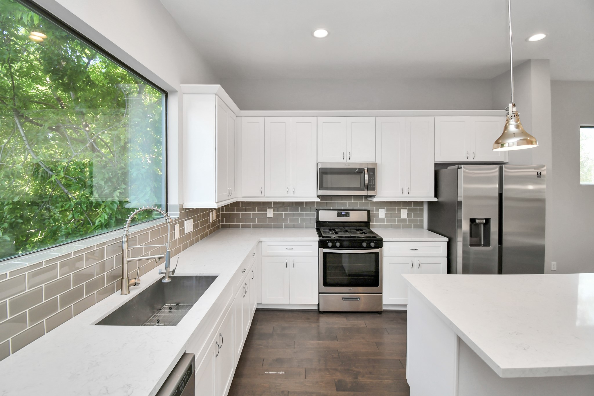 308 Palmer Street Houston, TX 77003 - Photo 9 of 36 a large kitchen with stainless steel appliances kitchen island granite countertop a refrigerator and a sink