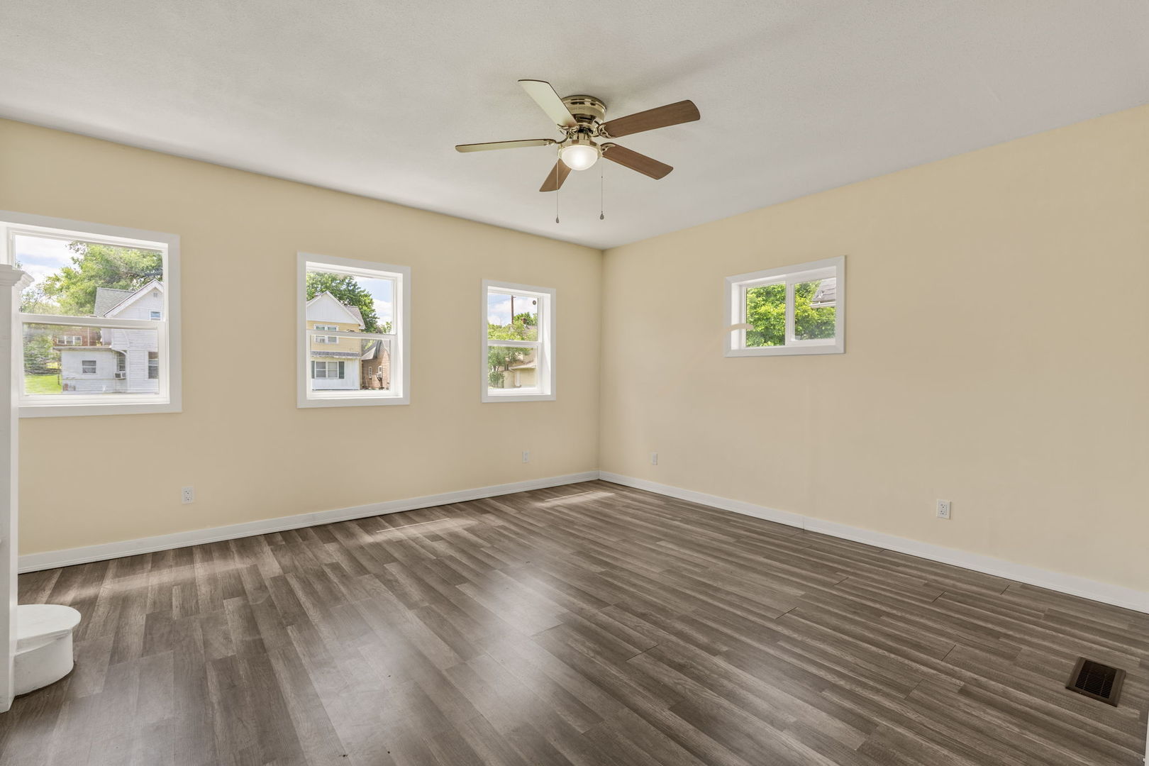 548 7th Avenue South Clinton, IA 52732 - Photo 4 of 23 a view of an empty room with a window and wooden floor