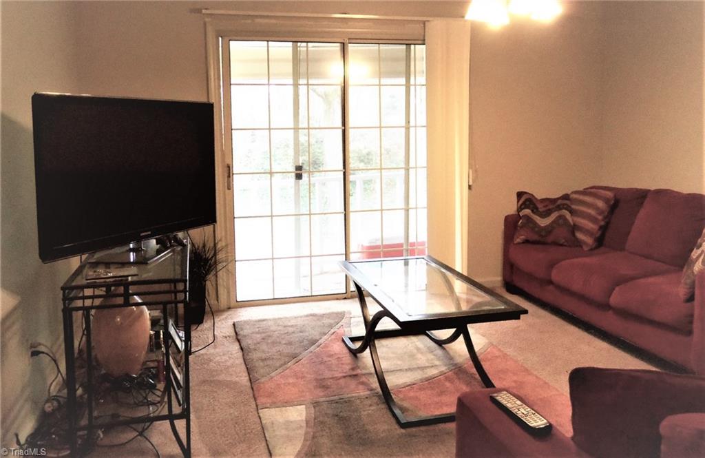 5669 Hornaday Road Greensboro, NC 27409 - Photo 3 of 13 Sunny family room with balcony.