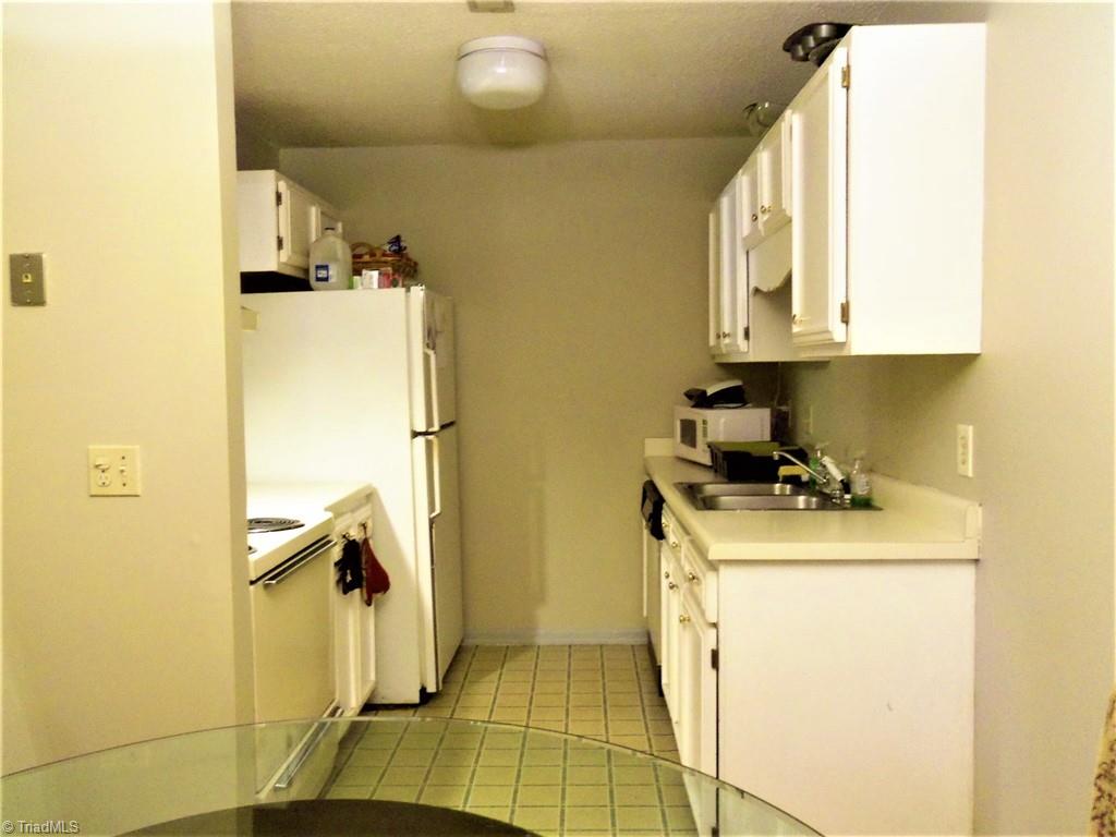 5669 Hornaday Road Greensboro, NC 27409 - Photo 5 of 13 Kitchen, refrigerator stays
