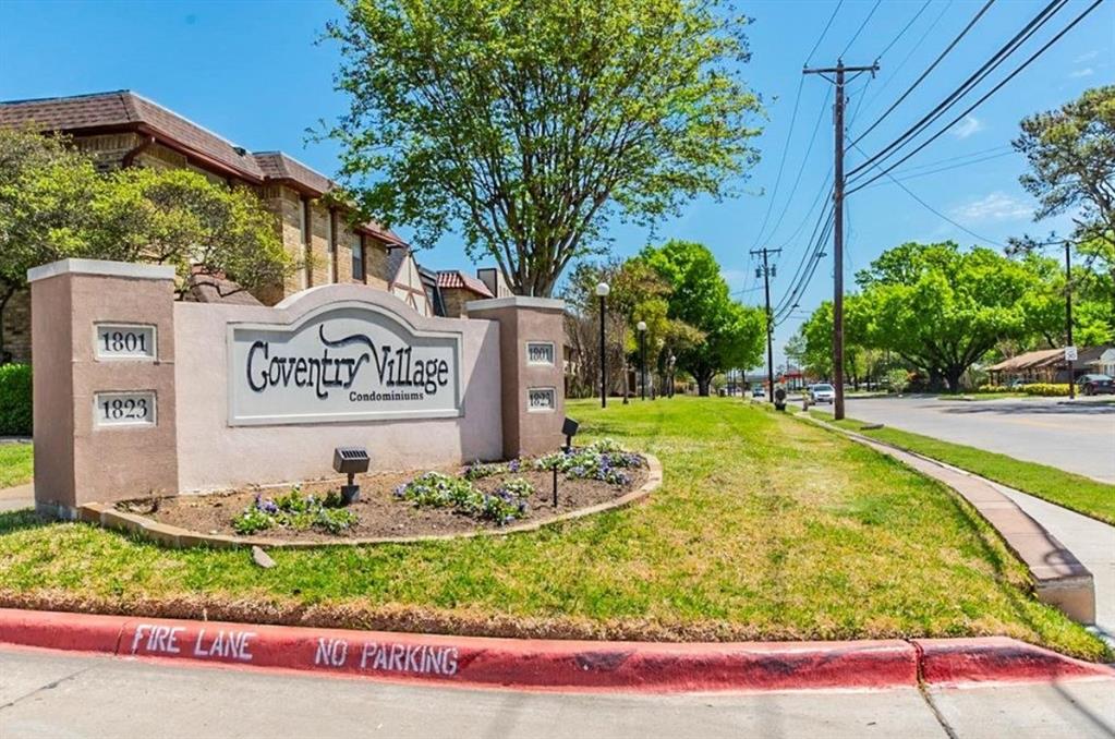 1821 East Grauwyler Road, Unit 188 Irving, TX 75061 - Photo 15 of 20 Coventry Village Condominiums entryway signage with stone-look posts, integrated address numbers, and landscaped planting beds