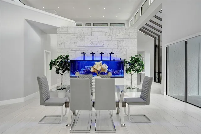 a large white kitchen with a large window