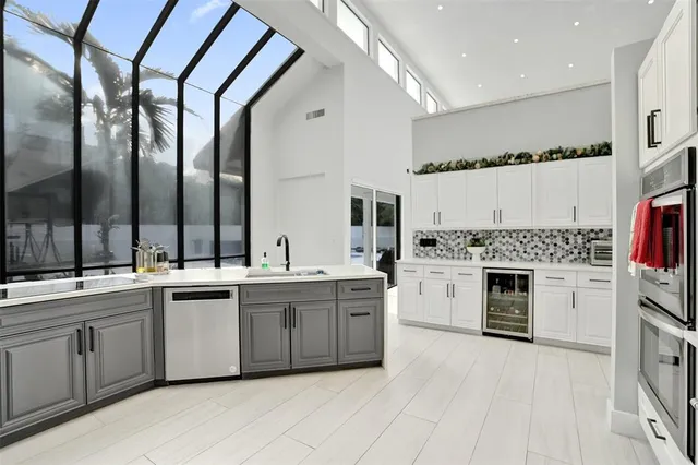 a living room with kitchen island furniture and a view of kitchen