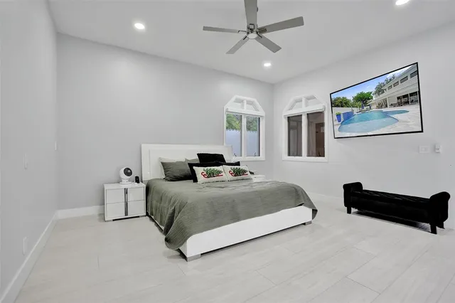 a living room with a bed furniture and a large window