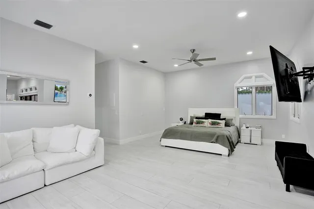 a bedroom with a large bed and a chandelier