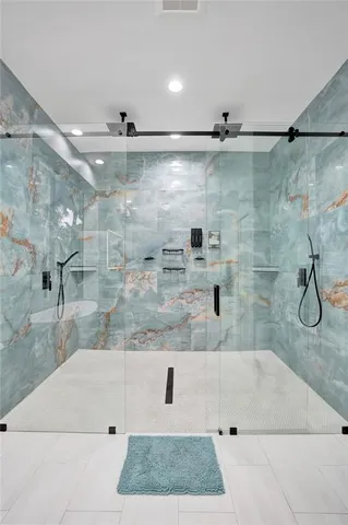 a bathroom with a granite countertop sink mirror and toilet