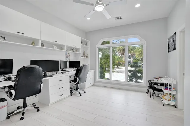 a view of the patio with couches and table and chairs with wooden fence