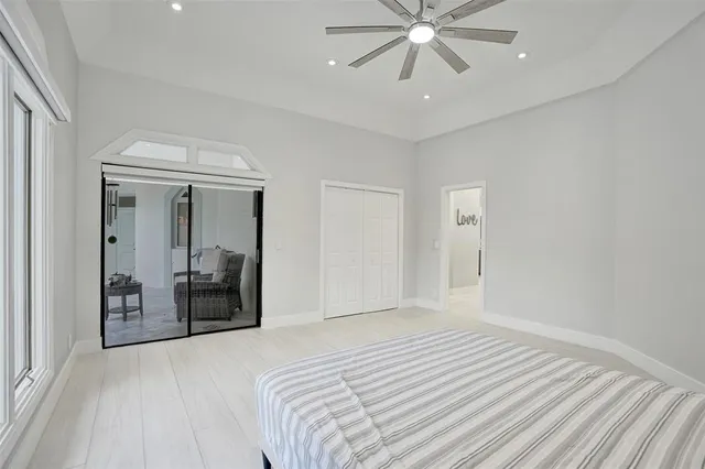 a living room with patio furniture and a potted plant