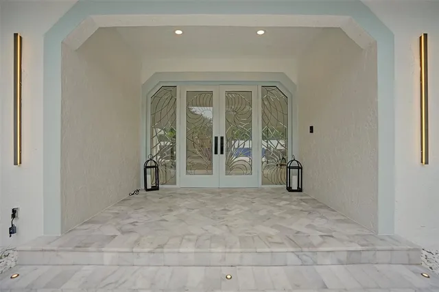 a view of a dining room with furniture and chandelier
