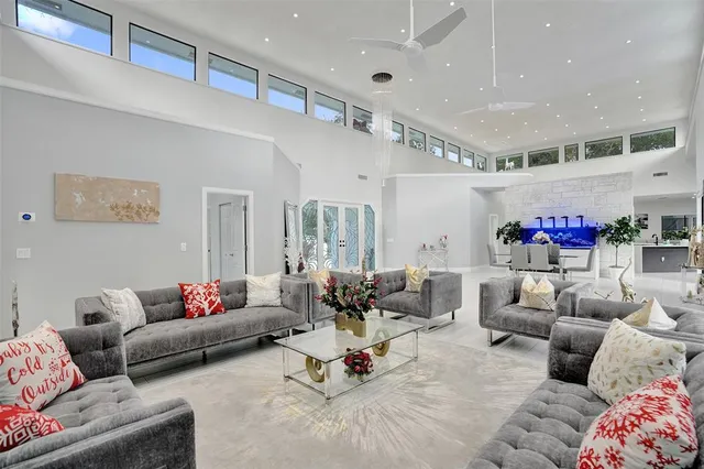 a view of a dining room with furniture and a chandelier