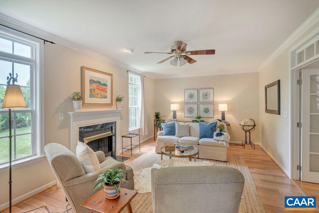 5363 Windy Ridge Road Charlottesville, VA 22903 - Photo 11 of 49 a living room with furniture a fireplace and a flat screen tv