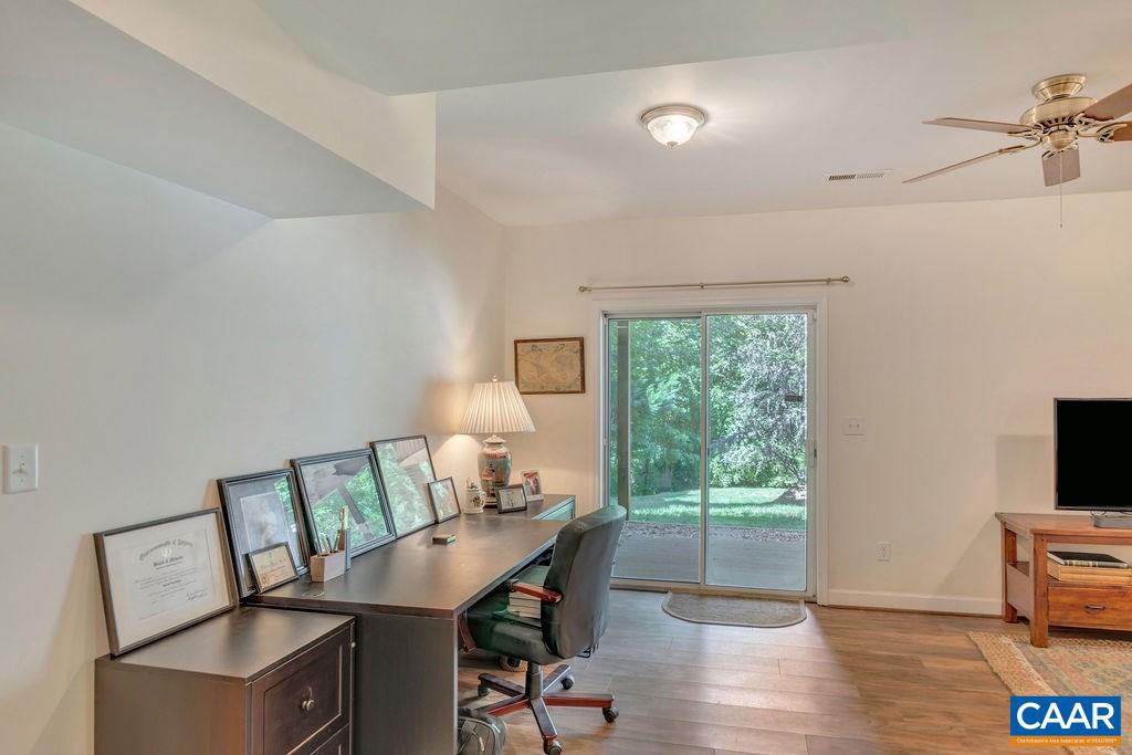 5363 Windy Ridge Road Charlottesville, VA 22903 - Photo 30 of 49 a view of a workspace with furniture and a window