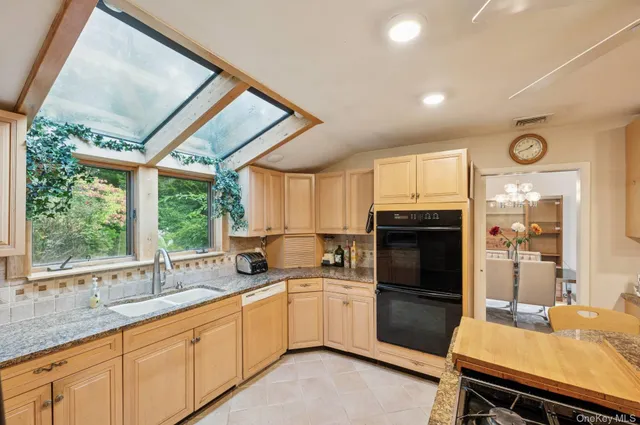 a kitchen with a sink appliances cabinets and a counter top space