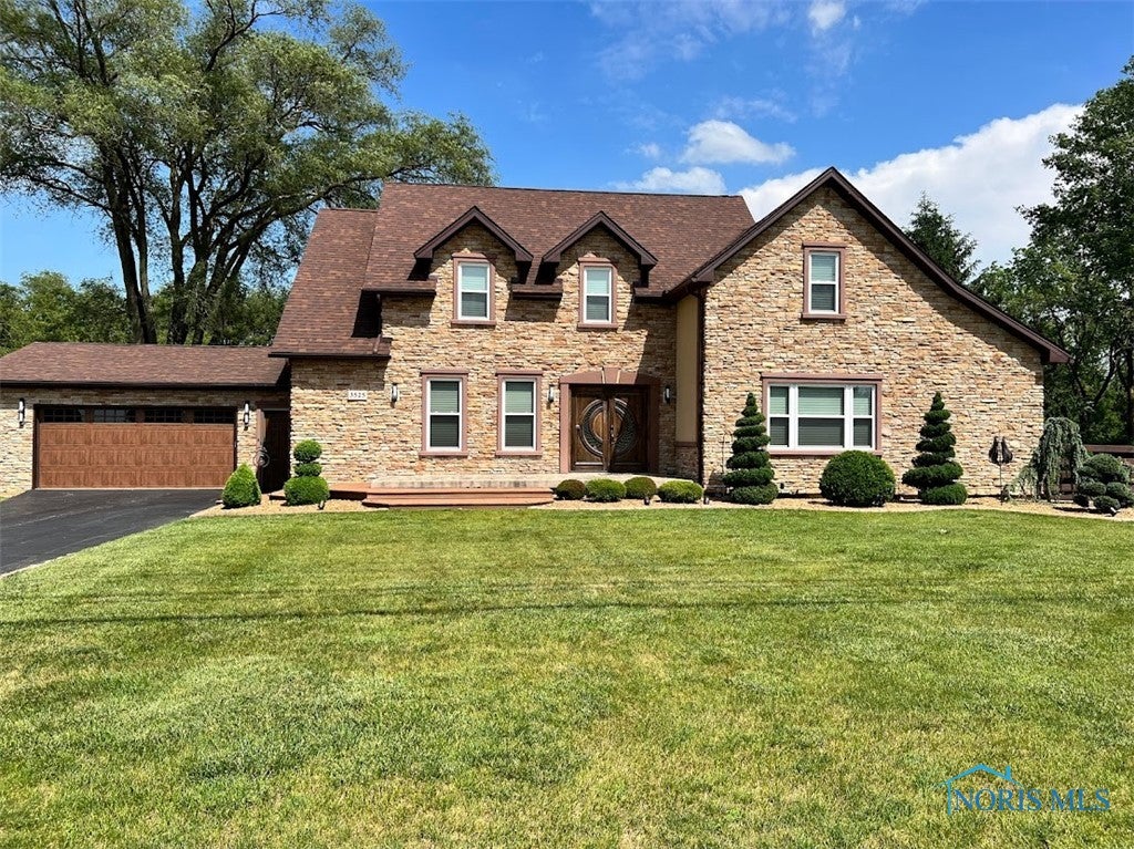 3525 Albon Road Maumee, OH 43537 - Photo 1 of 48 Front of home facing west. Exterior stone, roof, gutters, soffit, front door, all exterior doors, effis, and exterior lighting are all new in 2015.