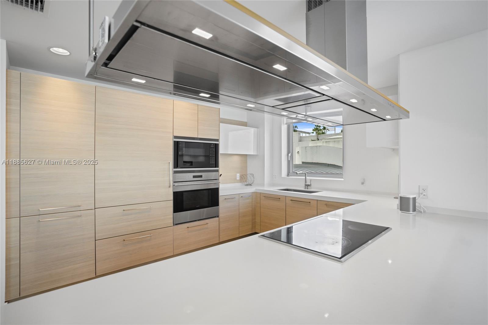 17111 Biscayne Boulevard, Unit 401 North Miami Beach, FL 33160 - Photo 12 of 66 a large kitchen with cabinets and stainless steel appliances