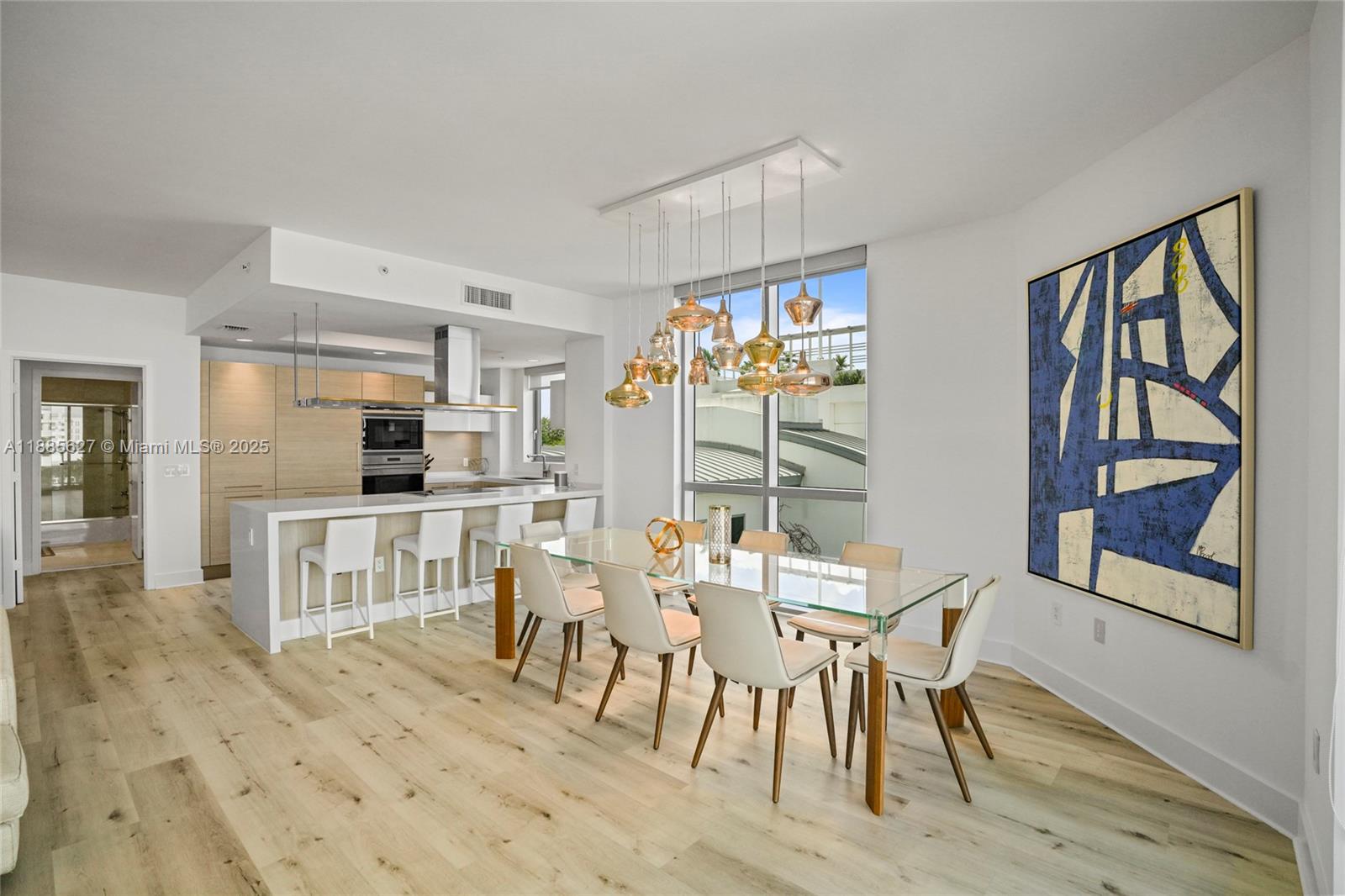 17111 Biscayne Boulevard, Unit 401 North Miami Beach, FL 33160 - Photo 17 of 66 a view of a dining room with furniture window and wooden floor