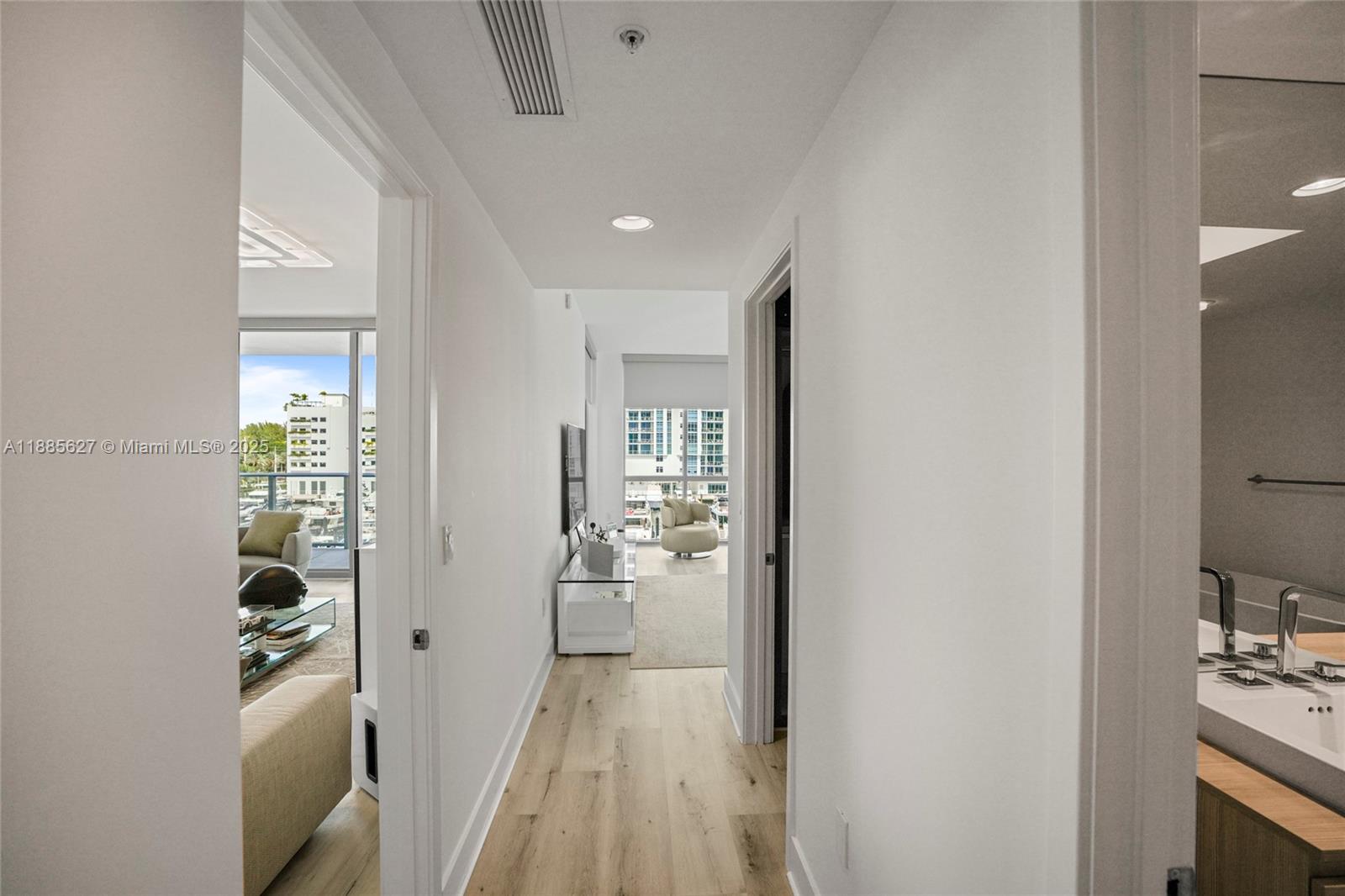 17111 Biscayne Boulevard, Unit 401 North Miami Beach, FL 33160 - Photo 19 of 66 a view of a hallway with wooden floor and a living room