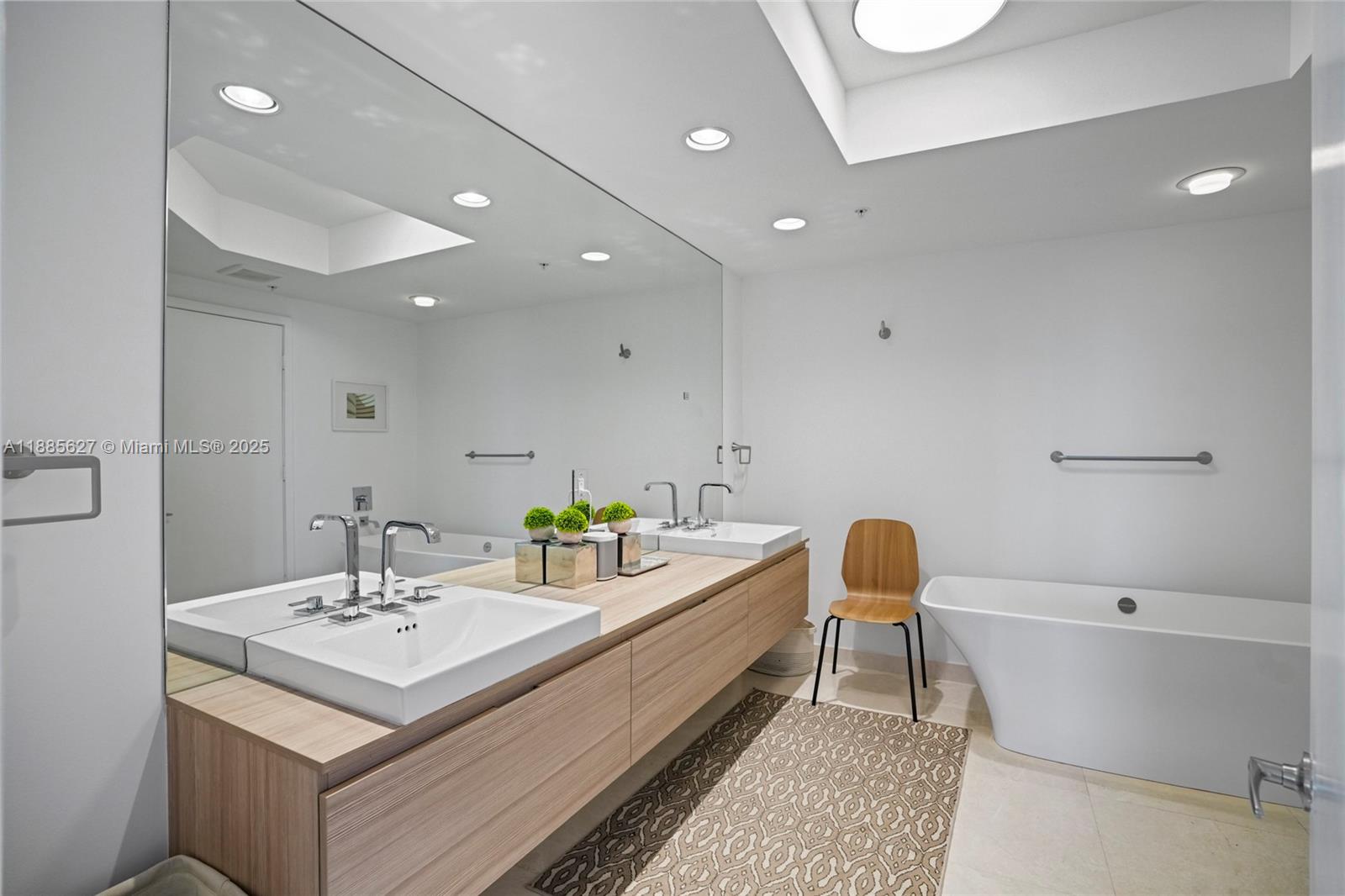 17111 Biscayne Boulevard, Unit 401 North Miami Beach, FL 33160 - Photo 23 of 66 a bathroom with a sink and a mirror