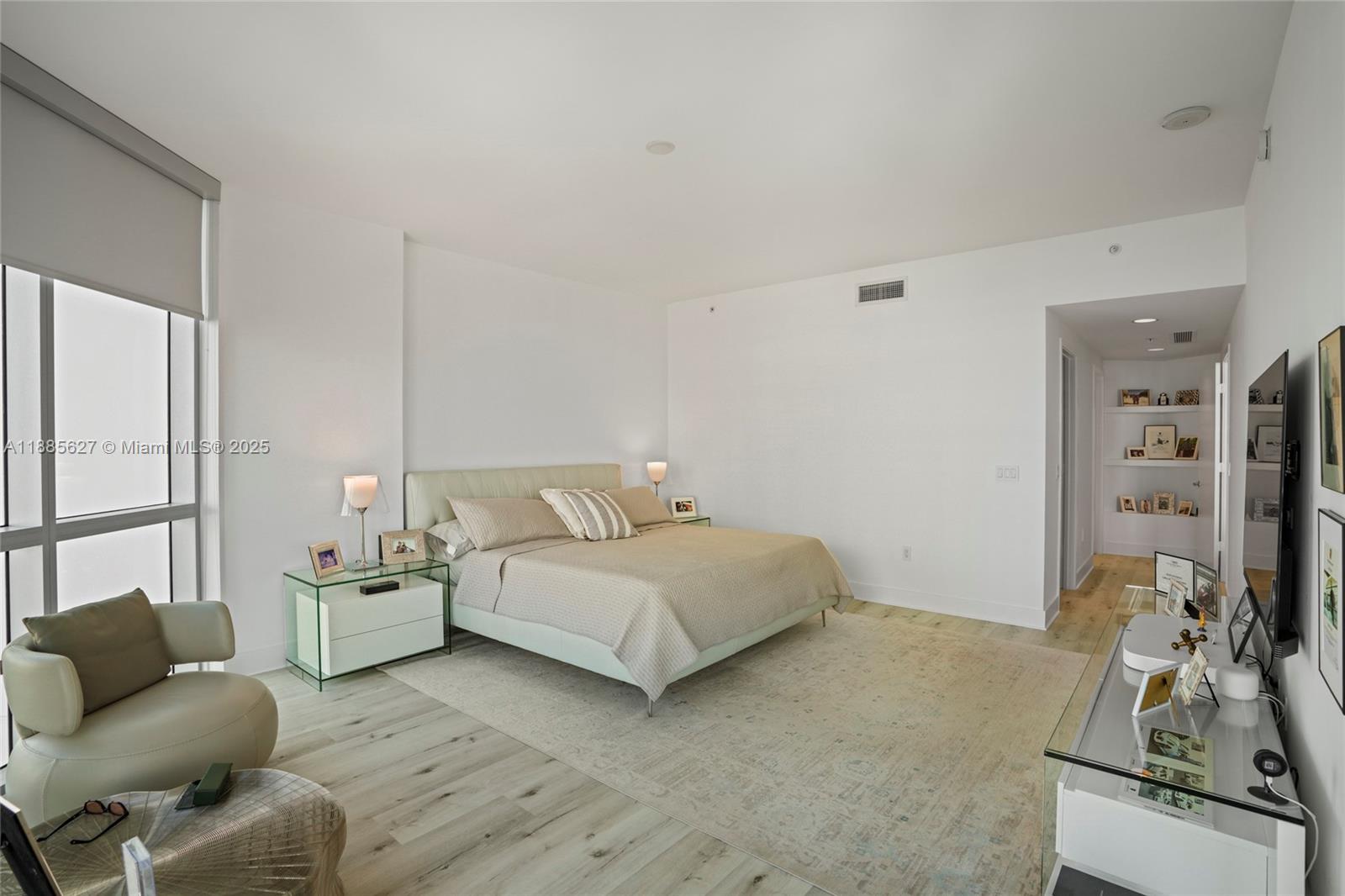 17111 Biscayne Boulevard, Unit 401 North Miami Beach, FL 33160 - Photo 25 of 66 a bedroom with a bed couch and a window