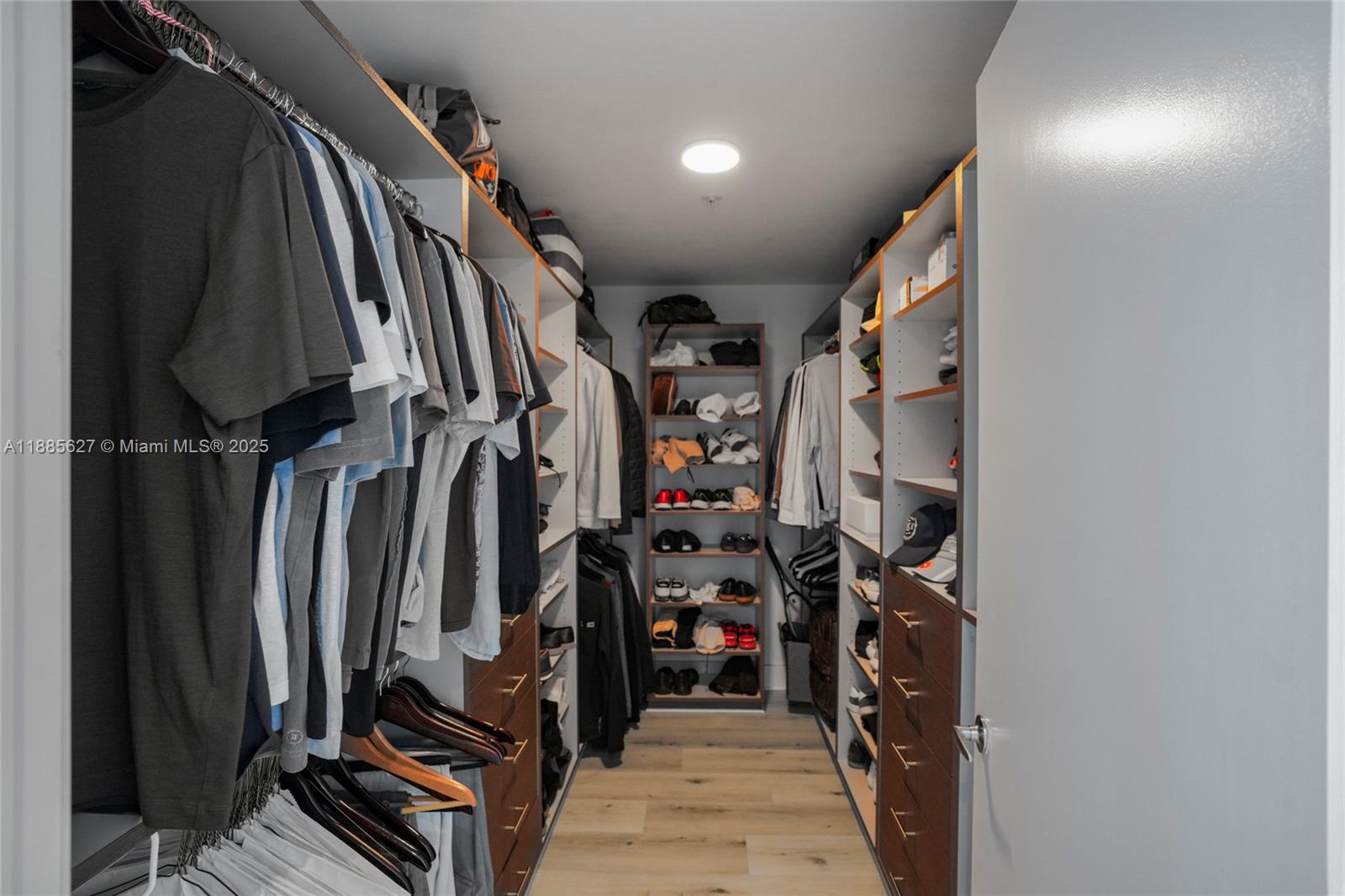 17111 Biscayne Boulevard, Unit 401 North Miami Beach, FL 33160 - Photo 28 of 66 a view of walk in closet with clothes and shoes