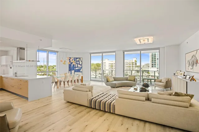 a living room with furniture and wall paintings