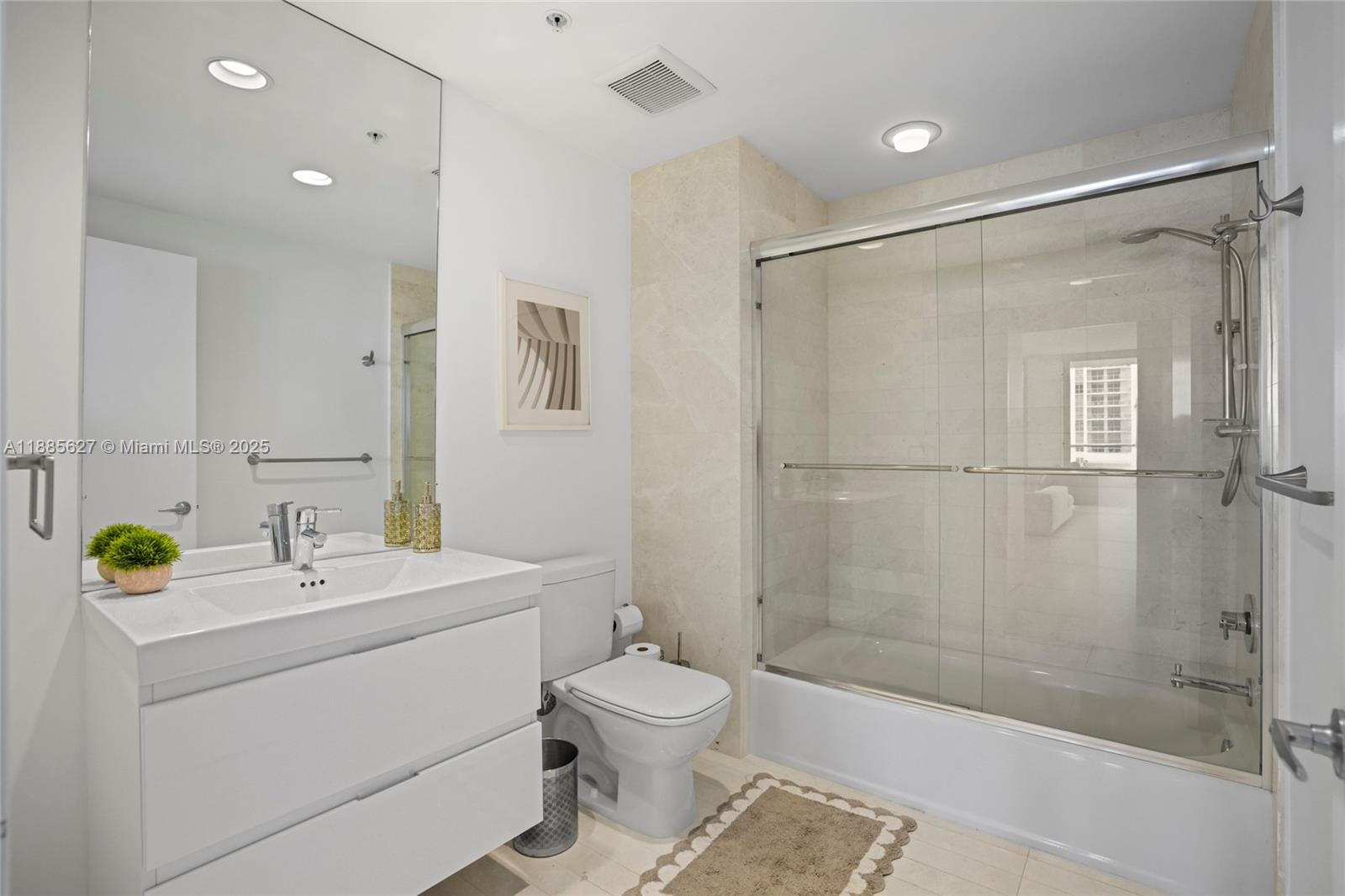 17111 Biscayne Boulevard, Unit 401 North Miami Beach, FL 33160 - Photo 32 of 66 a bathroom with a granite countertop sink toilet a mirror and shower