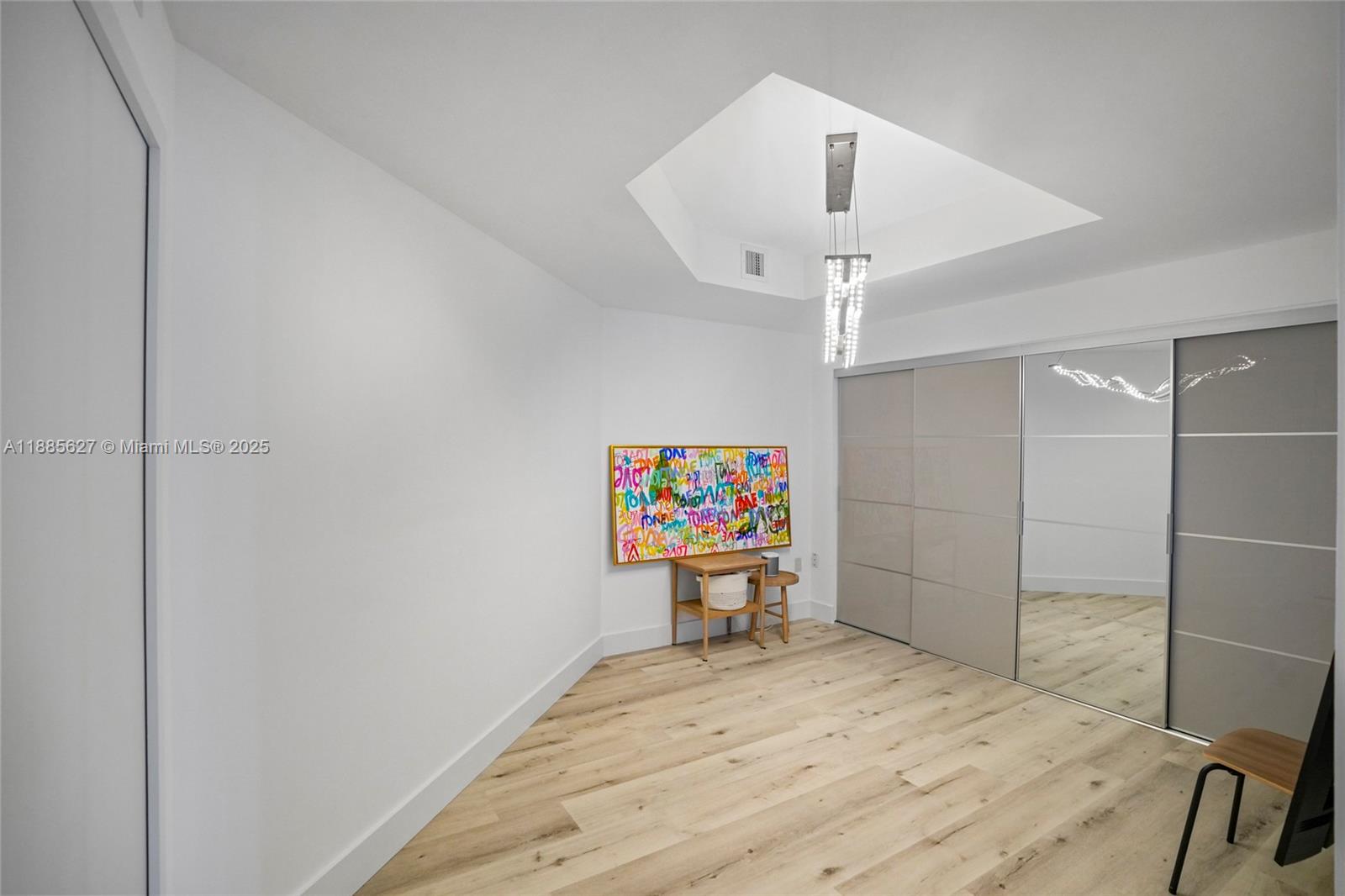 17111 Biscayne Boulevard, Unit 401 North Miami Beach, FL 33160 - Photo 34 of 66 a bedroom with a bed and a chandelier