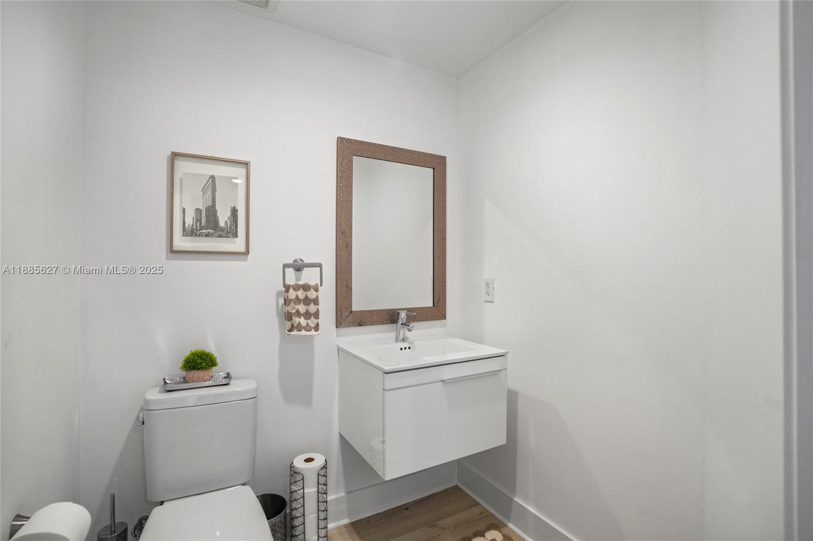 17111 Biscayne Boulevard, Unit 401 North Miami Beach, FL 33160 - Photo 37 of 66 a bathroom with a toilet a sink and mirror